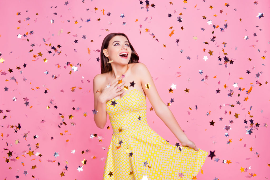 People victory luck fortune concept. Portrait of tender gentle cute lovely sweet pretty charming girl holding bottom of dotted dress with naked shoulders looking up confetti rain isolated background